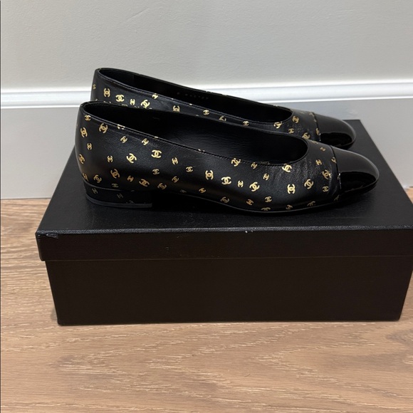 Brand new authentic CHANEL black leather flats with gold logos